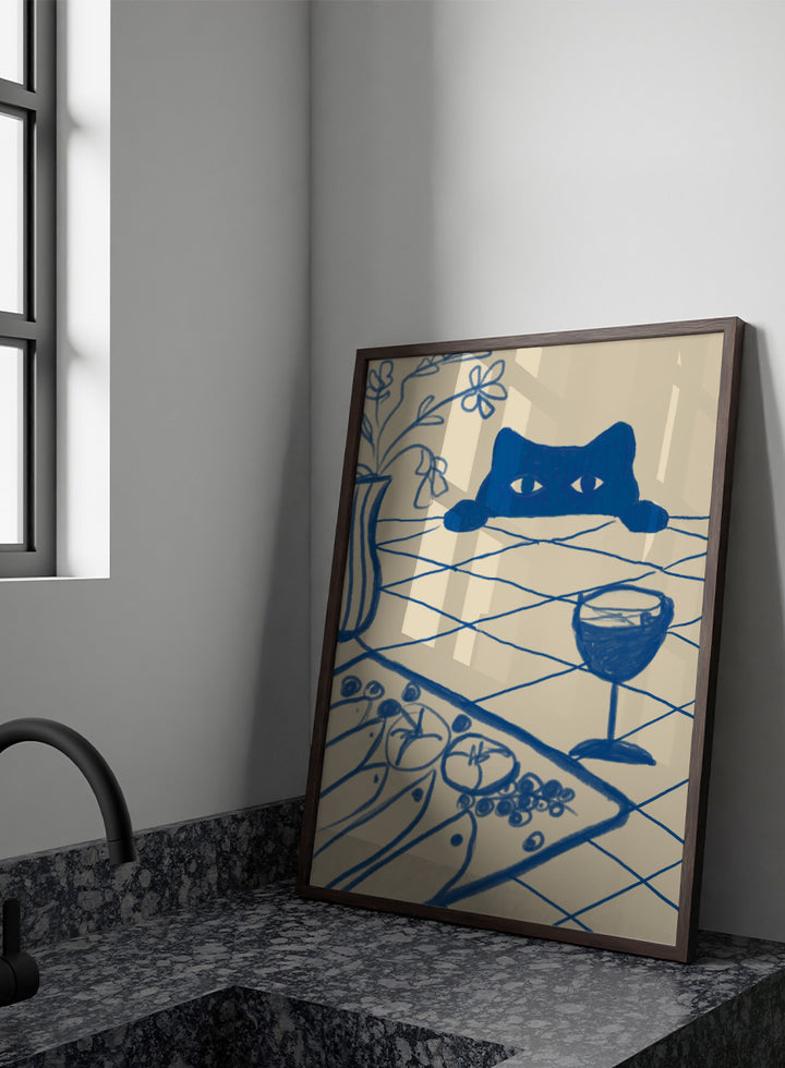 A stylized blue line-art illustration of a cat peeking over a table with a wine glass, flowers, and food, rendered in a cream background. Curious Blue Cat Dinner by The Art Concept is a playful cat art print featuring a peeking blue cat, table setting, flowers, and bold linework.