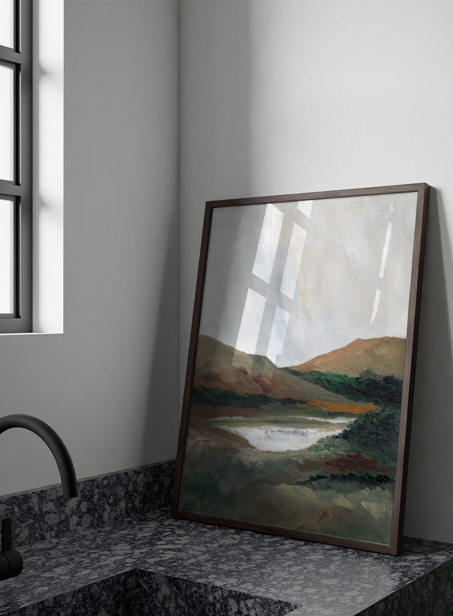 An impressionistic landscape painting of a river or waterfall flowing through a valley, with brown and green hills under a pale sky. Shop Serene Mountain Lake by Nikita Jariwala, a mountain landscape wall art print poster featuring a peaceful lake, wooded hills, and soft green tones.