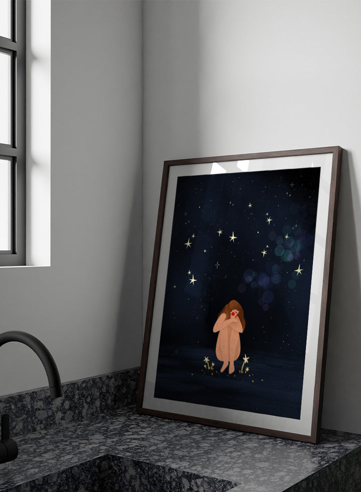 A framed art print featuring a whimsical illustration of a girl sitting on a dark blue starry night sky. Shop Starlit Solitude by Bea Müller, a figurative wall art print poster featuring a solitary woman beneath a star-filled night sky in deep blue tones.