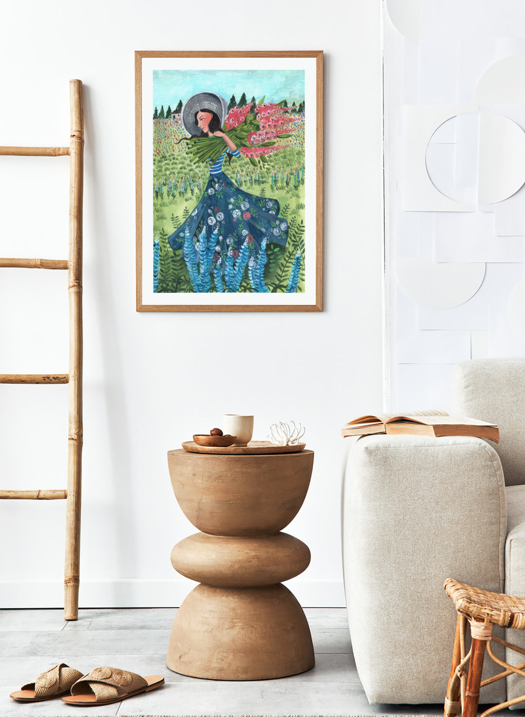 Woman in a floral dress holding flowers in a garden. Woman With Summer Flowers by Caroline Bonne Müller is a fine art print and wall poster featuring a woman carrying flowers through a colorful field.