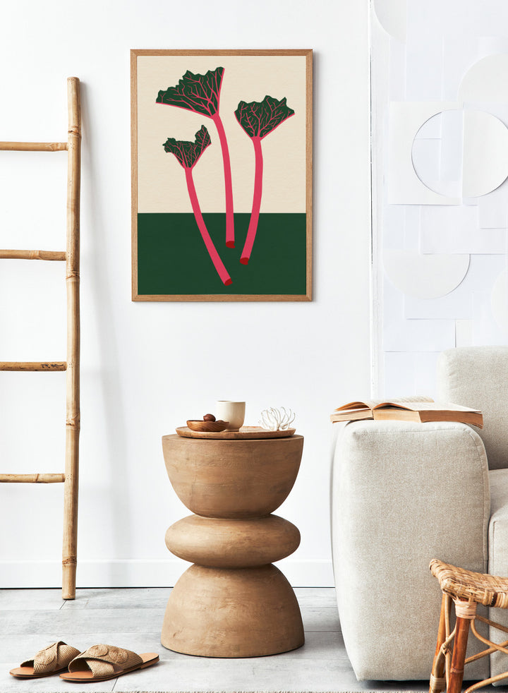 Illustration of red rhubarb stalks with green leaves on a beige and green background. Swedish Garden Rhubarb by Rosi Feist is a modern botanical art print with bold minimalist color and Bauhaus-inspired design. Officially licensed fine art poster with framing.
