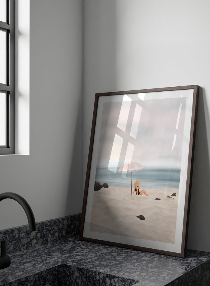 Woman under an umbrella on a beach with a calm ocean and sky. Serene Beach Scene by Flow Line is a coastal art print featuring a woman by the ocean, beach umbrella, seaside illustration, and summer wall art.