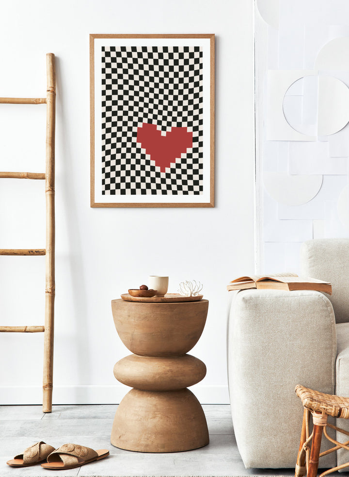 Checkered pattern with a red heart in the center. Pixel Heart by Frankie Kerr-Dineen features a red pixel heart on a wavy checkerboard background. Modern graphic art print and contemporary wall poster.