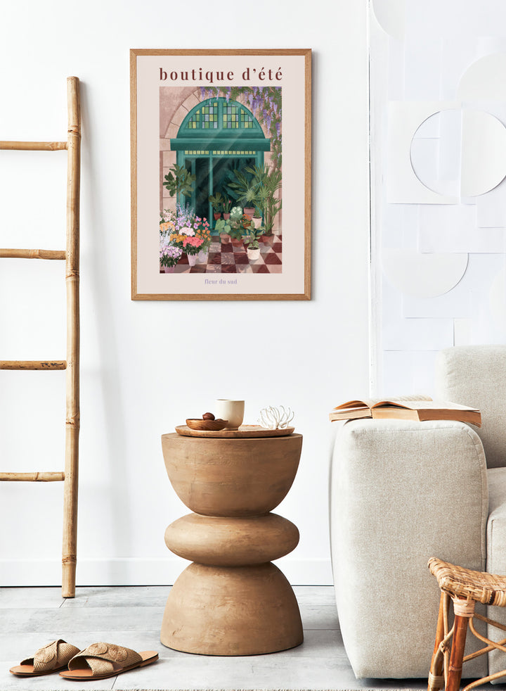 Illustration of a charming store entrance with plants and flowers, featuring the text 'boutique d'été' and 'fleur du sud'. French Flower Shop by Goed Blauw is a colorful storefront art print and wall poster featuring plants, flowers, and a green arch window in a warm European style setting.