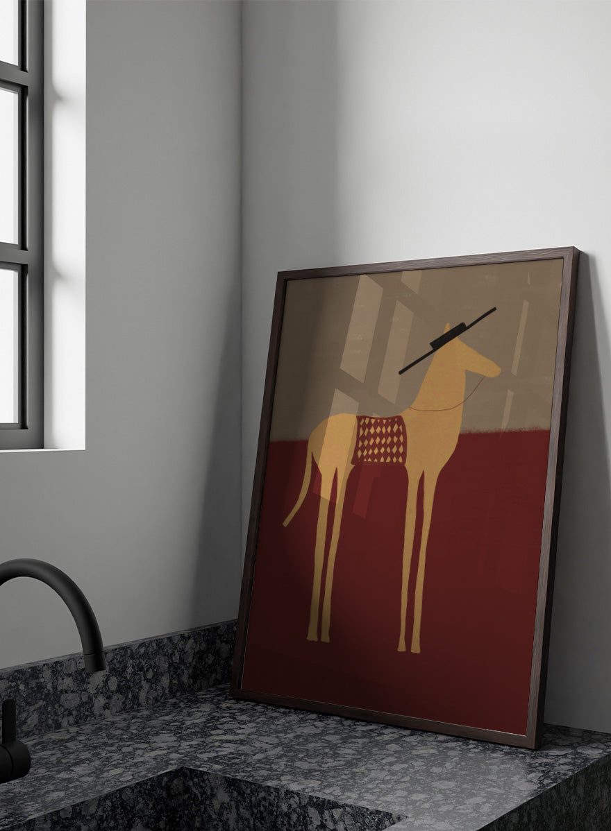 A stylized art print of a camel standing in profile, with a dark hat on its head and a patterned saddle blanket, set against a split beige and dark red background. Desert Horse with Sombrero by The Art Concept animal art print featuring a long-legged horse, patterned saddle blanket, black sombrero, and warm desert tones.