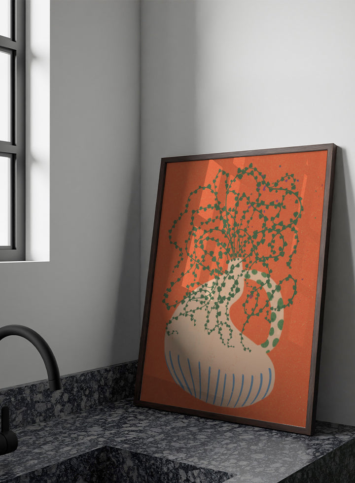 Shop Green Trailing Plant by Nikita Jariwala, a botanical wall art print poster featuring a trailing houseplant, cream vase, coral background, and bold green tones.