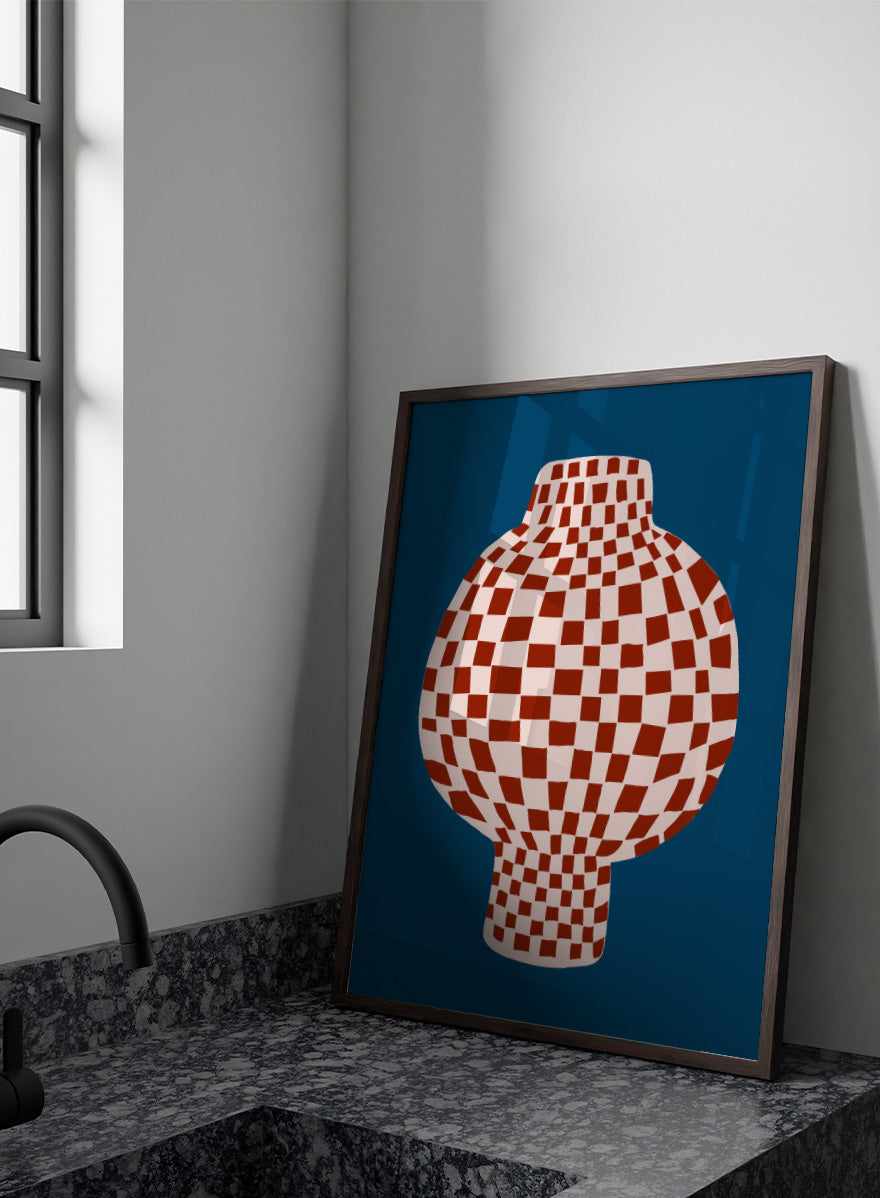 A stylized graphic illustration of a vase with a red and cream checkerboard pattern, set against a dark blue background. Optical Checkered Vase by The Art Concept is a modern still life art print featuring a red checkered vase on a deep blue background in a bold graphic style.