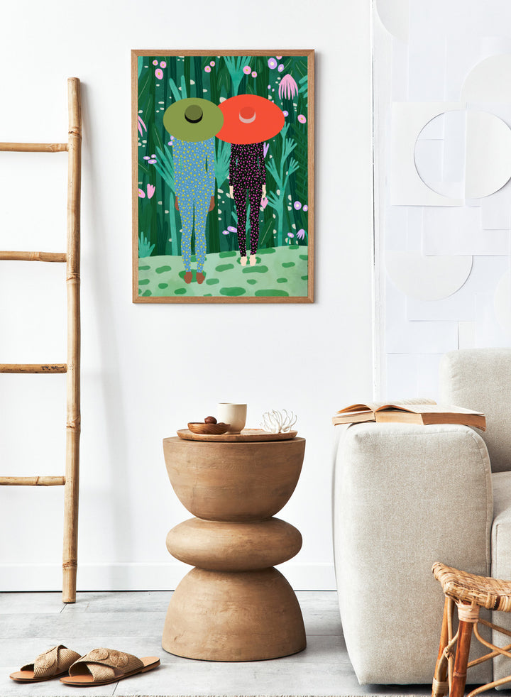 Two people with large hats walking through a lush, colorful forest. Jungle Pajamas by Jota de Jai is an officially licensed fine art wall poster about friendship and quiet connection, available framed or unframed.
