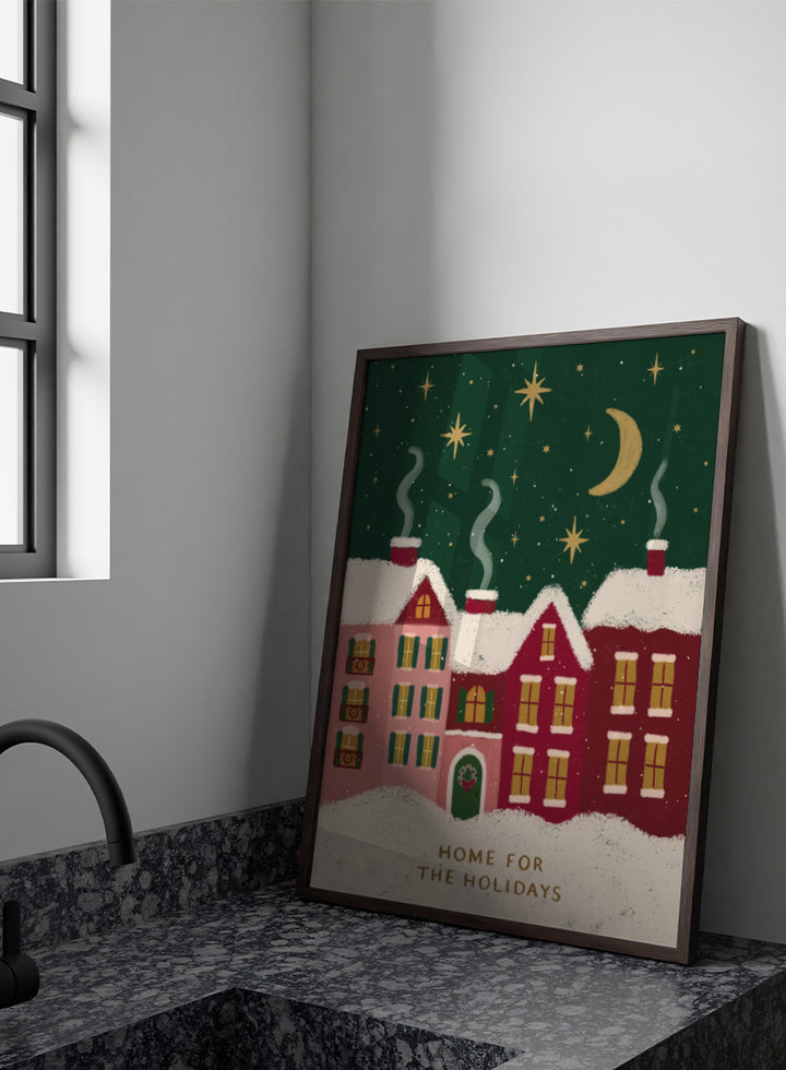 Shop Home For The Holidays by Katarzyna Gąsiorowska, a Christmas wall art print poster featuring snowy houses, glowing windows, stars, and a cozy winter village scene.