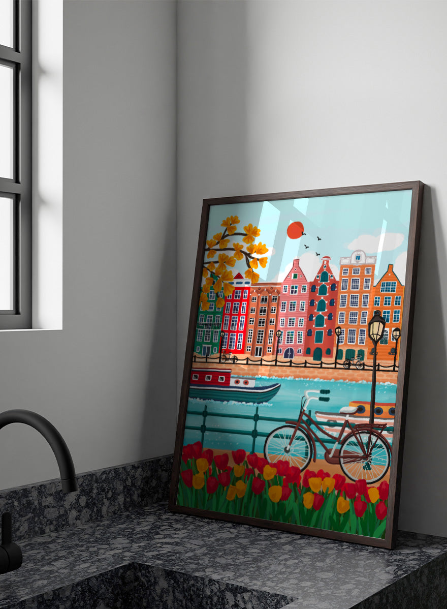 A colorful illustrated city canal scene with row houses, a bicycle, boats, flowers, and a bright sun.  Shop Colorful Amsterdam Canal by Nidhi Kachhadiya, a vibrant Amsterdam wall art print with canal houses, tulips, a bicycle, and colorful city charm.