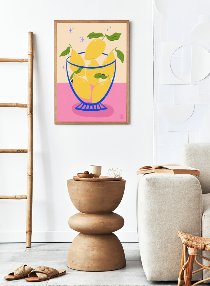 Illustration of lemons in a glass bowl with green leaves on a pink and beige background. Blue Floral Arrangement by Dirkie Nell is a botanical floral art print featuring deep blue flowers, folk inspired illustration, modern wall art, and expressive hand painted details.
