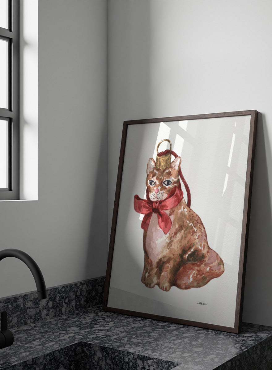 Shop Charming Cat Ornament by NKTN, a festive cat wall art print poster featuring a brown tabby with an oversized red bow and watercolor holiday style.