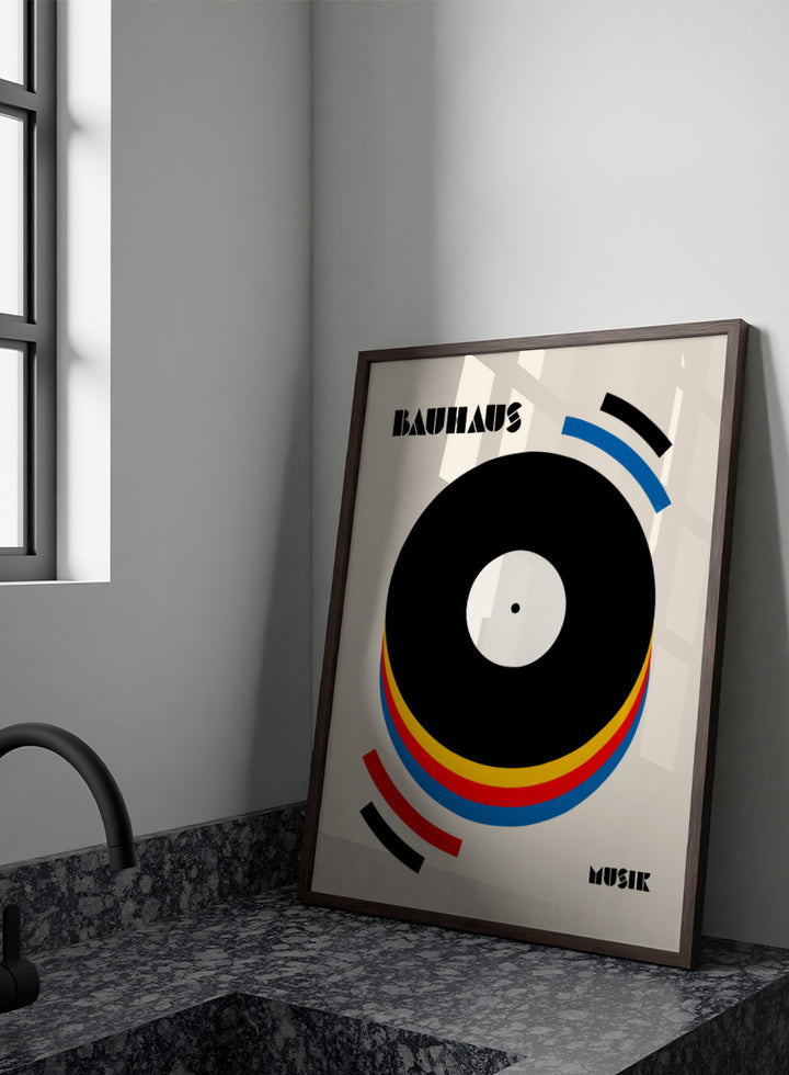 A Bauhaus-style poster featuring a large black vinyl record graphic with concentric red, yellow, and blue rings on a warm cream background, with the words &