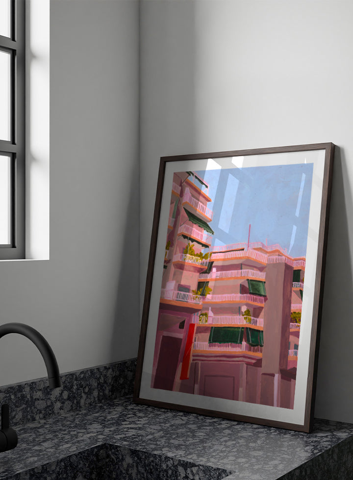 Shop Pink City Balconies by Sophia Novosel, a colorful city wall art print poster featuring pink apartment buildings, green awnings, balconies, and blue sky.