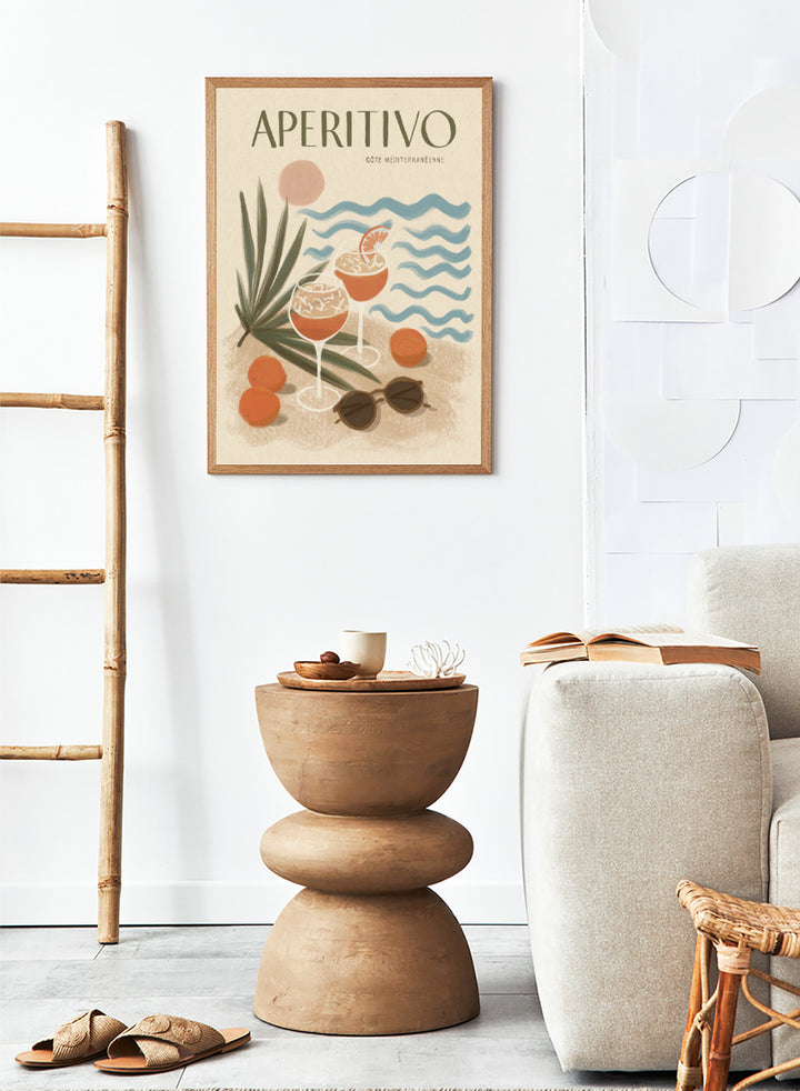 A travel-style poster reading “APERITIVO” with “CÓTE MEDITERRANÉENNE” beneath it, showing illustrated cocktails, citrus fruits, palm leaves, blue ocean waves, and sunglasses on a warm beige background.Aperitivo Beach Day by Katarzyna Gąsiorowska Mediterranean art print featuring spritz cocktails, oranges, sunglasses, and vintage coastal style.