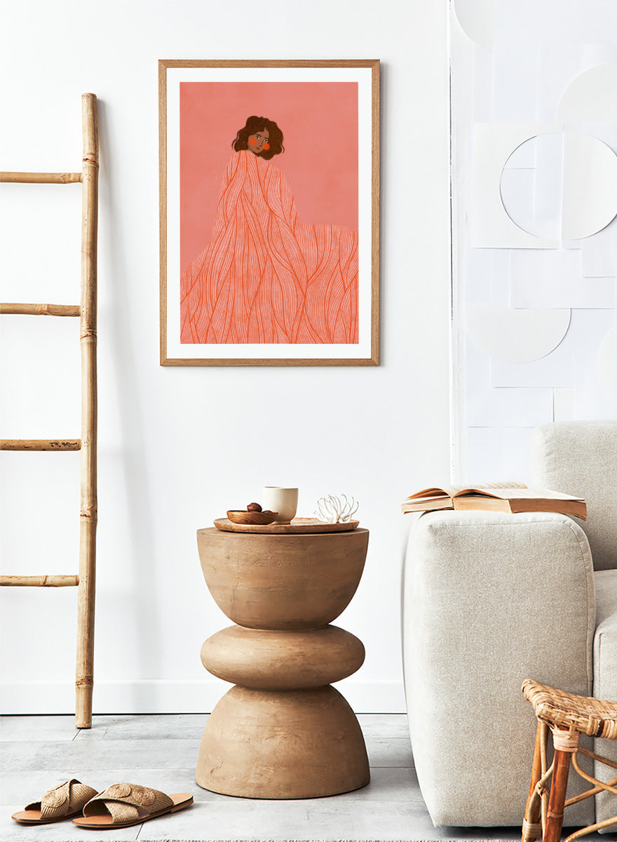An art print featuring an illustration of a woman with dark curly hair wrapped in a flowing coral-orange patterned dress against a solid pink background. Coral Woman Dreaming by Bea Müller portrait art print featuring a woman wrapped in a flowing coral dress with fine red lines and modern graphic detail.