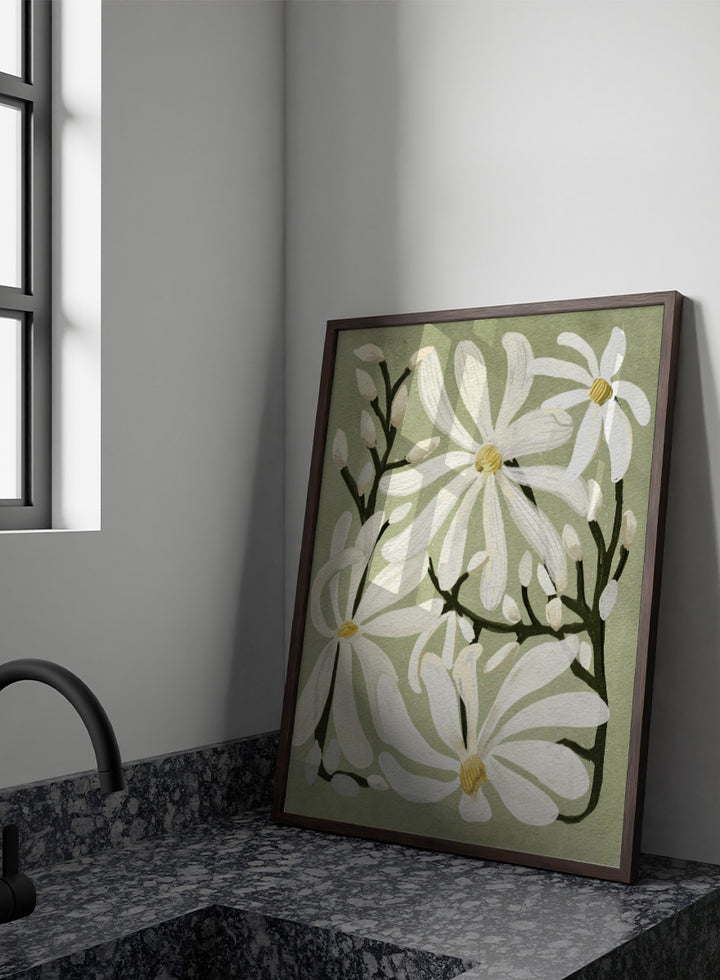 A botanical art print featuring white magnolia flowers with yellow centers and dark green stems on a muted sage green background. Shop Star Magnolia Floral Art Print by Katie O&