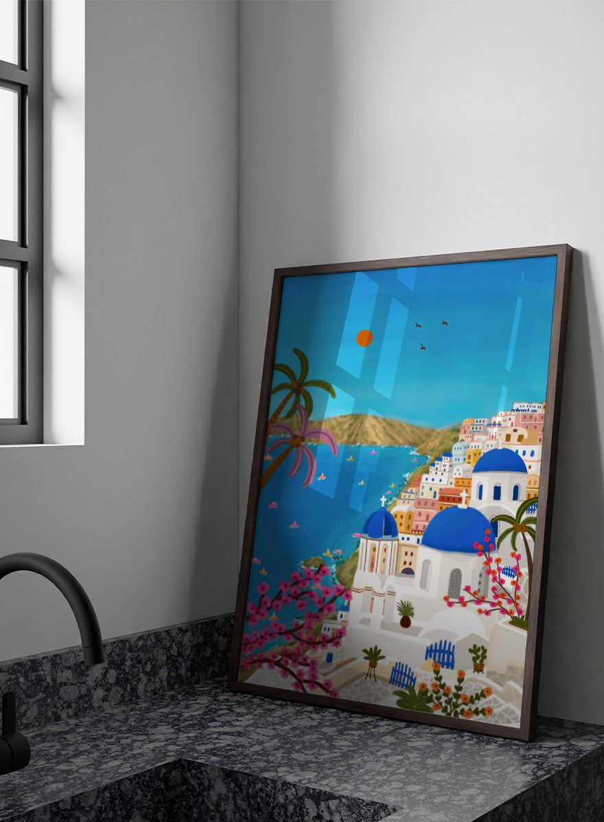 Shop Santorini Blue Domes by Nidhi Kachhadiya, a colorful Greek island wall art print inspired by Santorini, blue domes, whitewashed architecture, and Mediterranean views. A colorful illustrated coastal village scene with white buildings, bright blue domes, palm trees, pink flowering branches, a blue sea, and a clear sky with a sun and birds. 