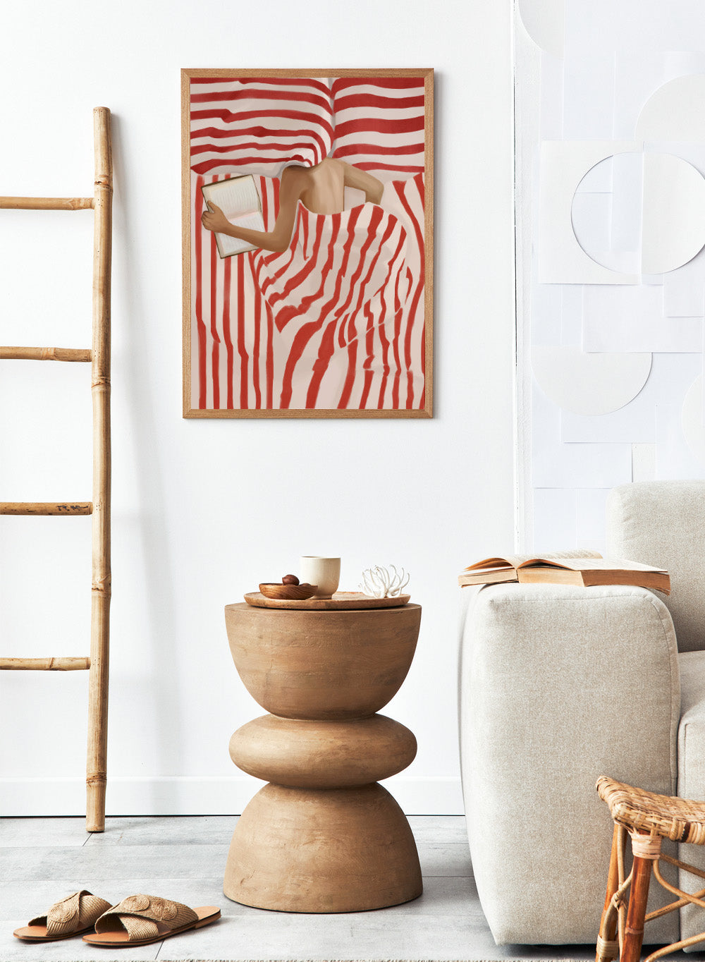 Between the Lines by Flow Line art print shows a woman reading in bed wrapped in red striped bedding. A modern lifestyle wall poster inspired by slow evenings.