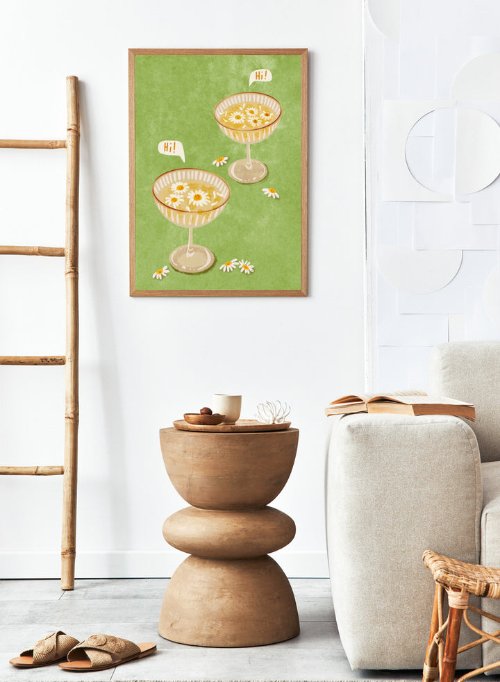 Illustration of two cocktail glasses with daisies on a green background. Hi by Raissa Oltmanns is a modern cocktail art print featuring smiling daisy drinks in playful contemporary wall poster style.