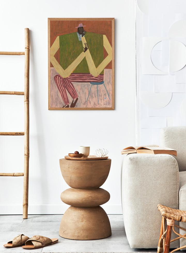 Surrealistic painting of a person sitting on a chair with geometric shapes and abstract design. Take a Moment by Studio IMO (Ibi Meier-Oruitemeka) is a modern figurative art print featuring a seated figure in a calm, reflective pose, designed as a contemporary wall art poster.