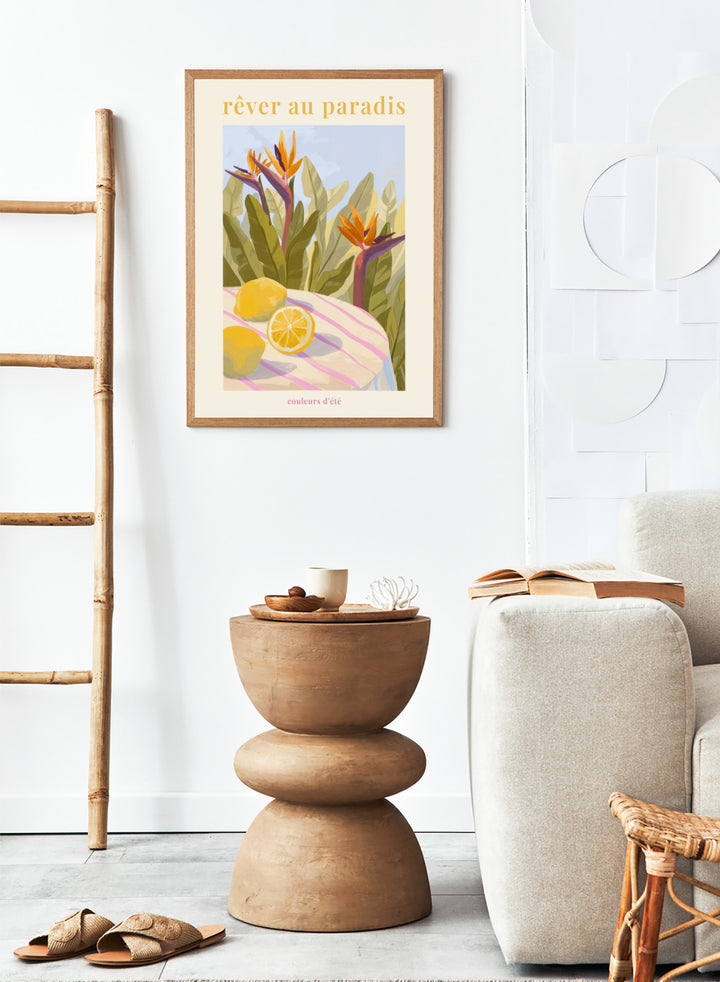 Illustration of tropical flowers and lemons with 'rêver au paradis' text on a light background. Rêver Au Paradis Lemon by Goed Blauw is a summer art print and wall poster featuring lemons, tropical leaves, and bird of paradise flowers in warm, vibrant tones.