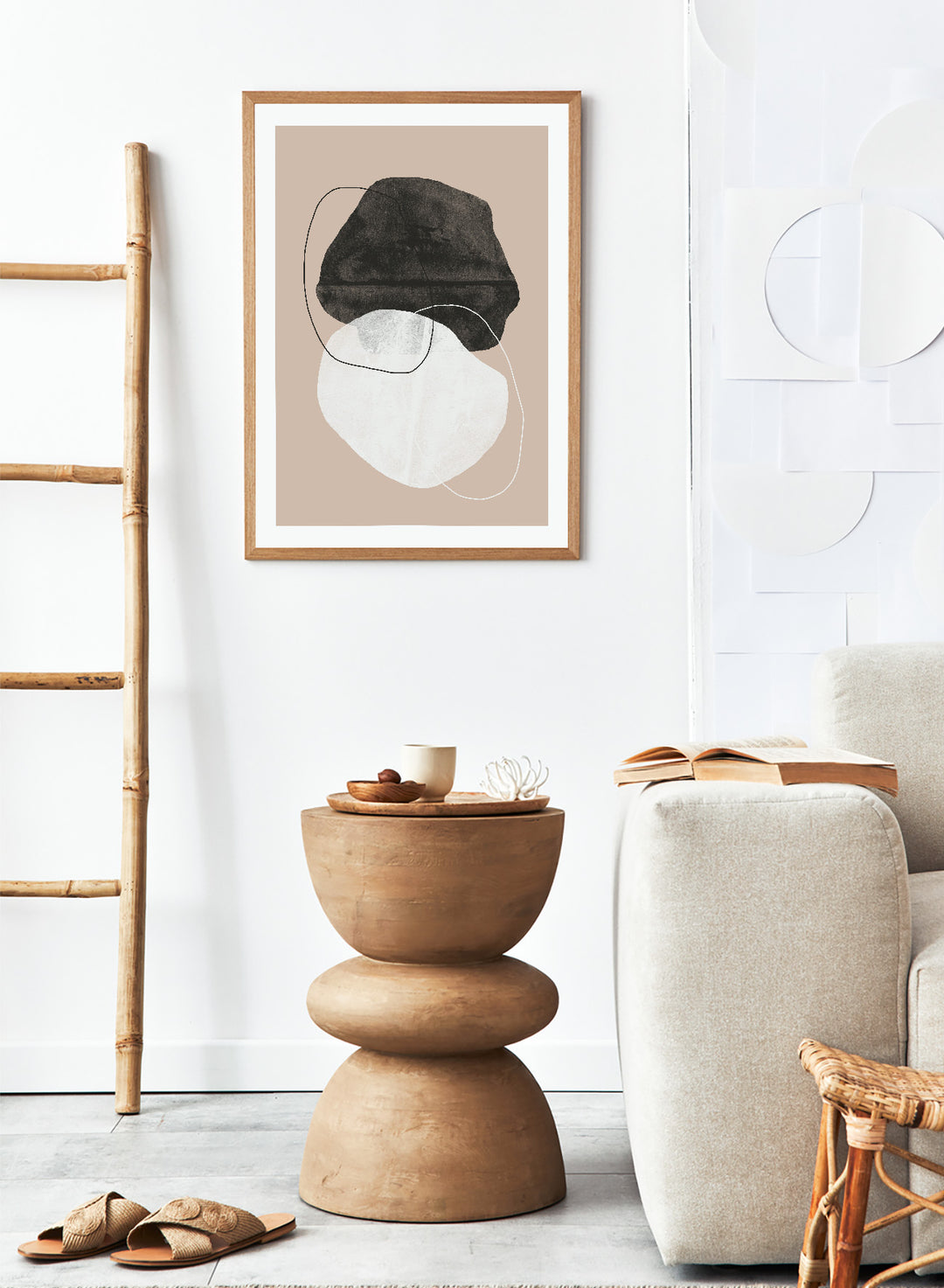 Abstract art piece with a black shape and white circle on a beige background. Earthy Abstractions by The MIUUS Studio is a minimalist abstract art print and wall poster featuring organic shapes, neutral tones, and modern textured design.