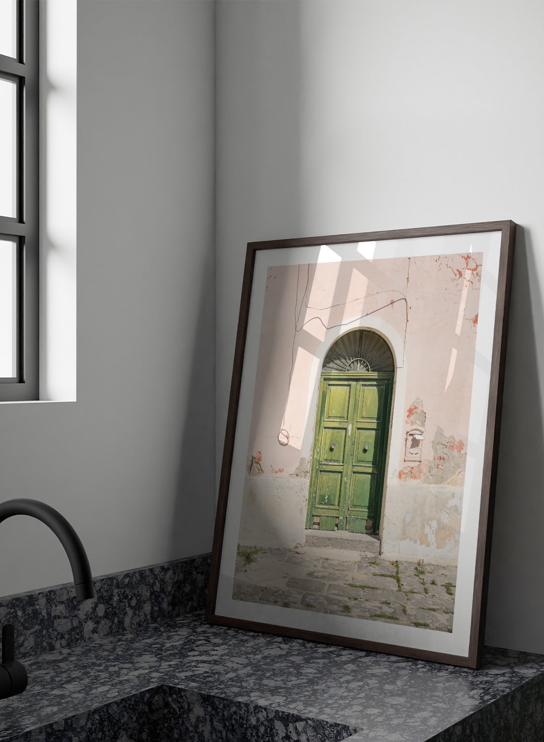 Green door on a pink wall with peeling paint. Old World Green Door by Henrike Schenk features a vintage European doorway, weathered architecture, pastel walls, travel photography, and wall art.