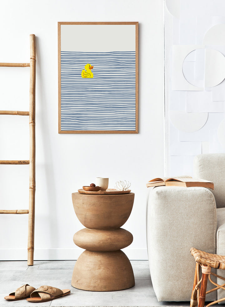 Yellow Duck Afloat art print by Little Dean. Playful duck illustration with blue ocean stripes, modern minimalist wall art, contemporary poster design.