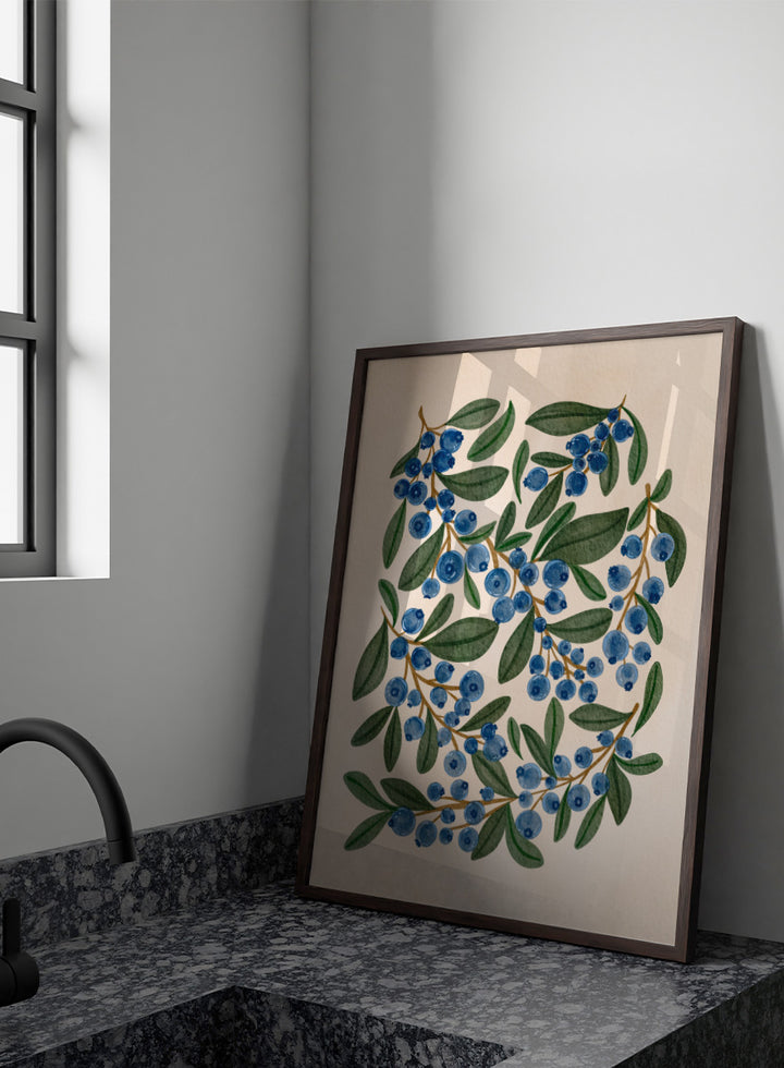 Botanical art print of blueberry branches with green leaves on a warm beige background. Shop Fresh Blueberry Sprigs by Nikita Jariwala, a botanical wall art print poster featuring blueberry branches, deep blue berries, and leafy green summer detail.