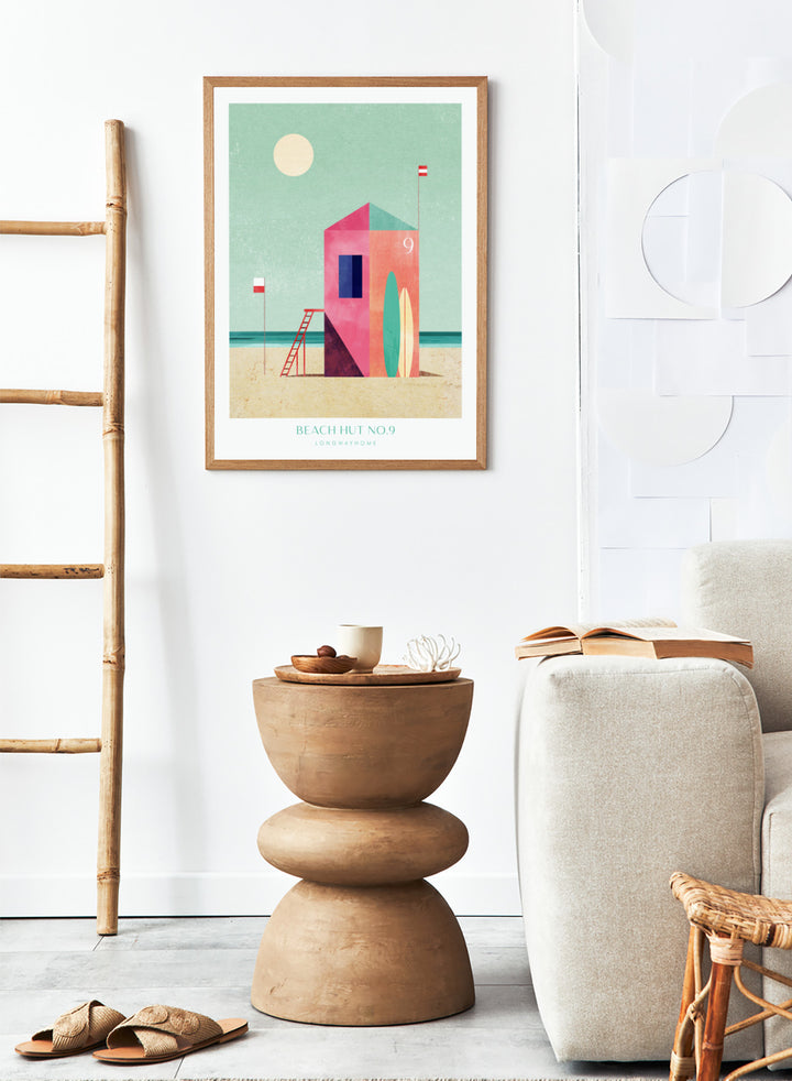 Colorful beach hut illustration with a minimalistic design on a light green background. Beach Hut Number Nine by Longwayhome is a retro inspired coastal art print featuring a colorful beach hut, surfboards, and minimalist seaside design.
