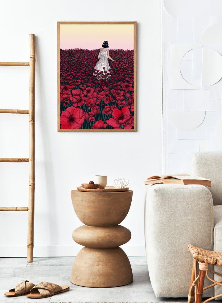 Woman in a white dress standing in a field of red flowers with a gradient sky. Field of Poppies by E.C. Mazur is an officially licensed art print featuring a woman standing in a red poppy field. Illustrated landscape wall poster.