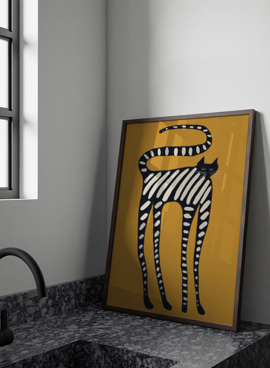 A stylized art print of a cat with black and white stripes on a mustard yellow background. Elegant Striped Cat by The Art Concept playful cat art print featuring a long black cat with cream stripes and an oversized curved tail on mustard yellow.