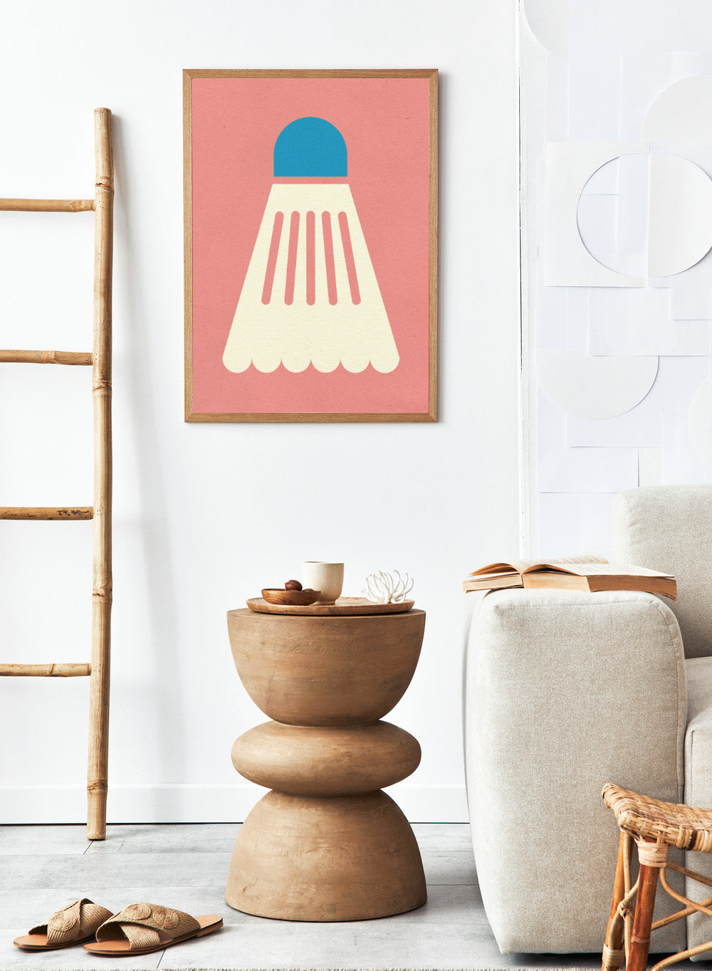 Shuttlecock with blue top and white body on a pink background. Badminton White Blue by Rosi Feist is a modern sports wall art print featuring a minimalist shuttlecock design in bold color and graphic poster style.