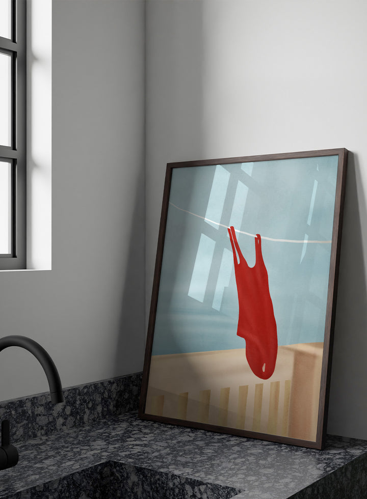 Red swimsuit hanging on a clothesline against a blue sky. Red Swimsuit On Balcony by Flow Line features a red swimsuit drying in the sun, bringing Mediterranean charm and summer vacation style to your walls.