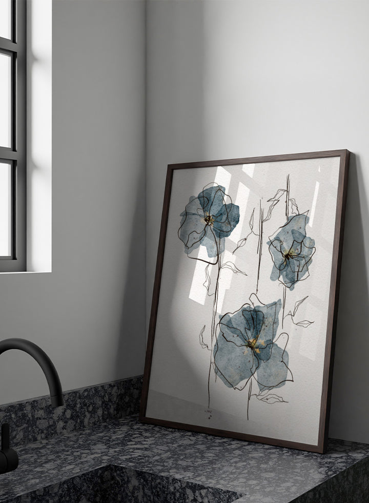 A framed watercolor and ink floral art print featuring three blue-gray flowers with black sketch lines on a white textured background. Shop Delicate Blue Blooms by Ankie Kooi, a modern floral wall art print poster featuring abstract watercolor flowers, botanical line art, blue, cream, and black.