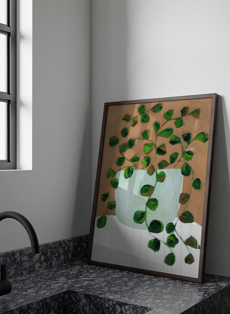 Shop Warm Houseplant Pot by Nikita Jariwala, a botanical wall art print poster featuring a trailing houseplant in a green pot with warm green tones.