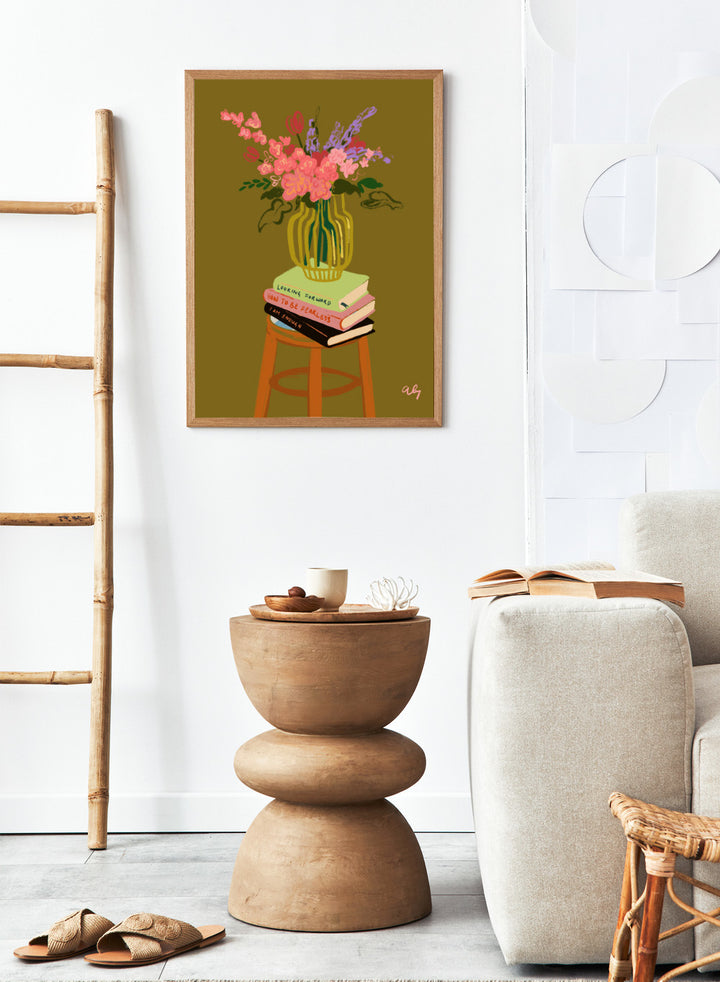 Vase with flowers on a stack of books on a stool against a green background. Floral Vase by Arty Guava is a modern flower still life art print with a striped vase and book stack. Officially licensed wall poster.