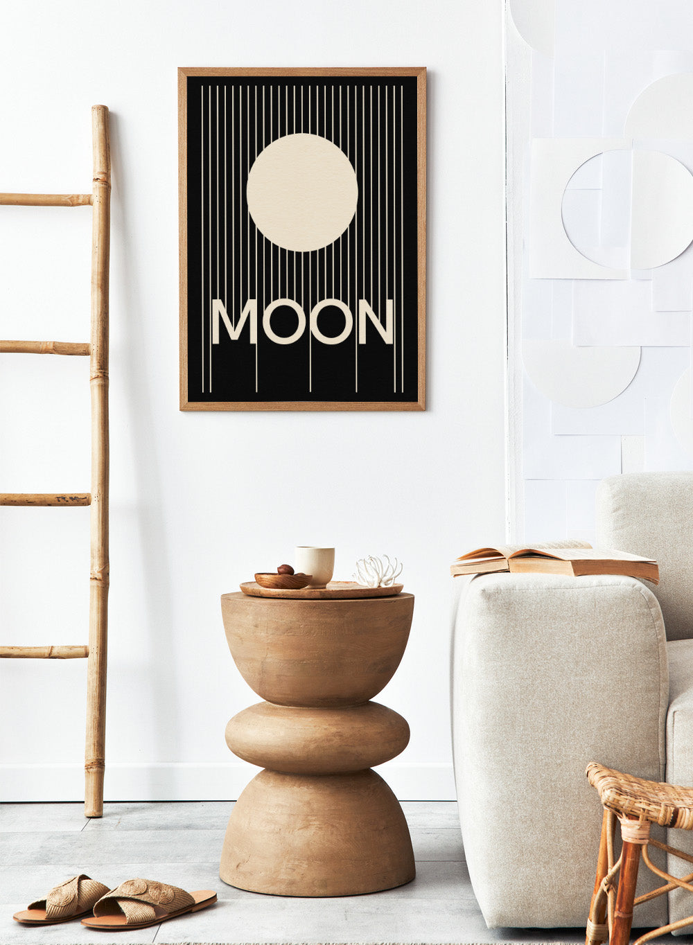 Poster with a stylized moon and the word 'MOON' on a black background. Moon by Rosi Feist is a bold minimalist Bauhaus-inspired art print with a cream circle and graphic lines. Officially licensed modern poster with framing.