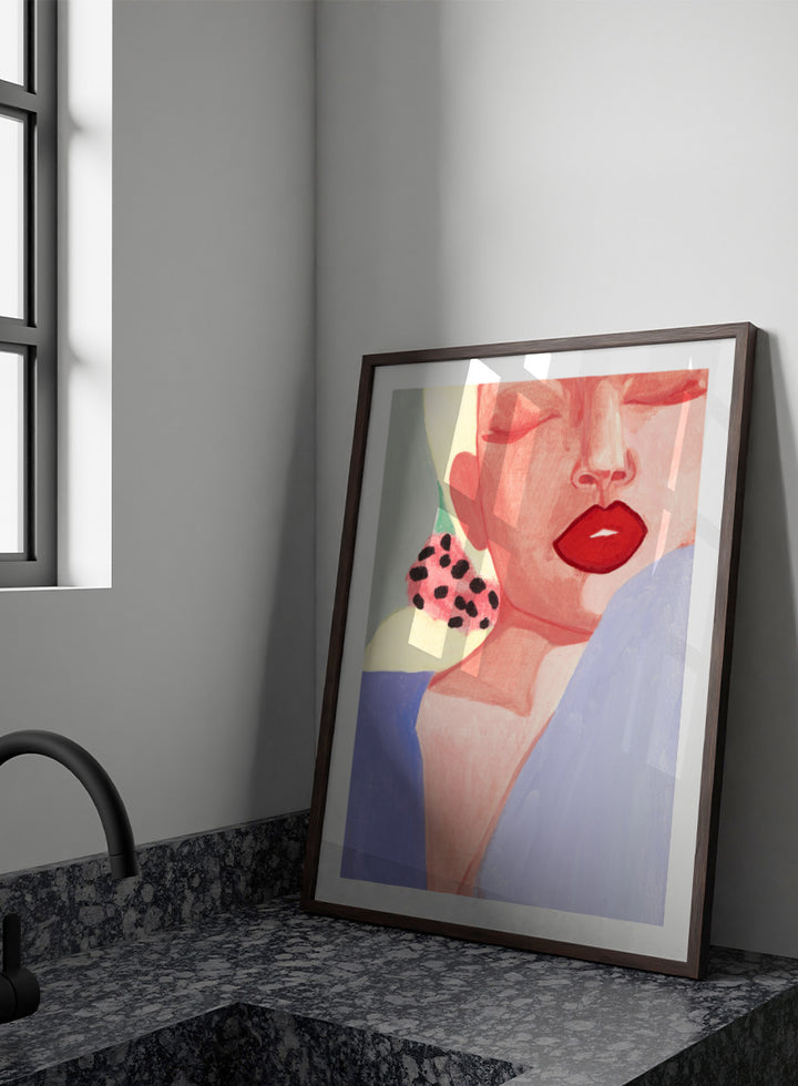 Shop Red Lips by Sophia Novosel, a modern woman portrait wall art print poster featuring bold red lips, closed eyes, soft pink tones, and a spotted earring.