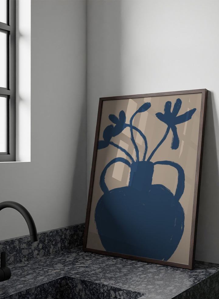 A minimalist art print featuring a dark blue silhouette of a vase with two handles and abstract flower stems, set against a warm beige background. Minimalist Blue Blooms by The Art Concept is a modern floral art print featuring a deep blue vase, loose flowers, and a warm beige background.