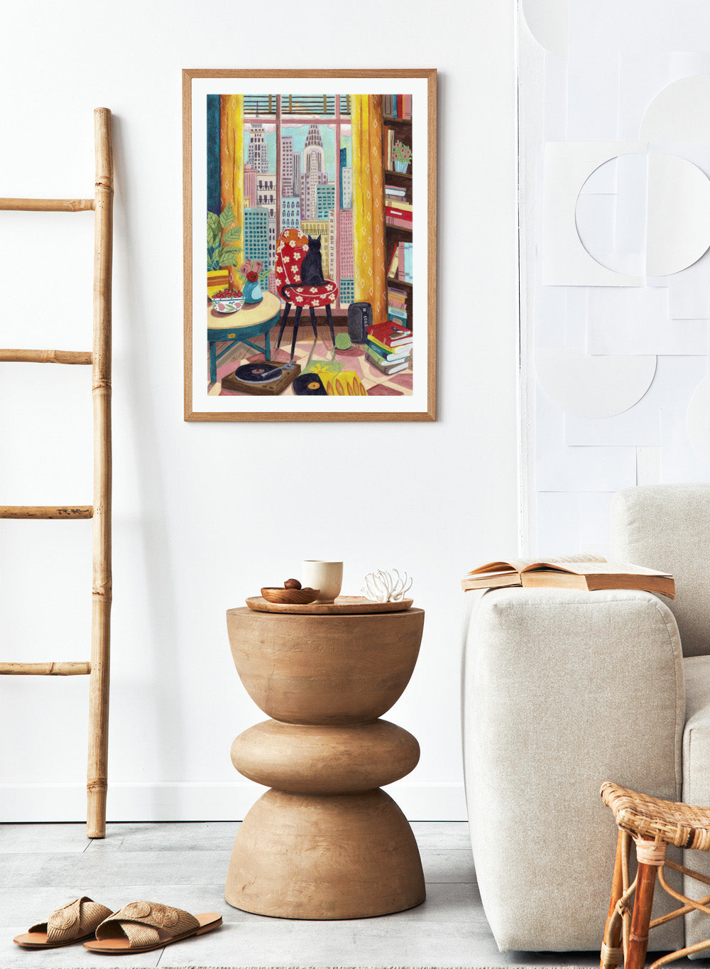 Colorful interior scene with a cat on a chair, books, and cityscape view. Black Cat City View by Caroline Bonne Müller is a fine art print and wall poster of a black cat by a window with city skyline and colorful interior.