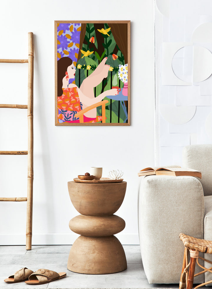 Illustration of a woman sitting by a pool with flowers and birds in a colorful garden setting. Morning on the Balcony by Rafaela Mascaro fine art print poster featuring woman with coffee, birds, lush greenery, botanical scene, modern contemporary wall art.
