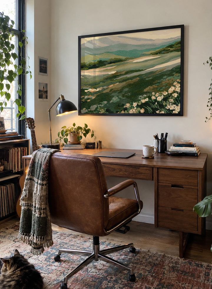 Shop Wildflower Mountain Landscape by Nikita Jariwala, a mountain wall art print with rolling green hills, cream wildflowers, and soft sage and blue-gray tones.