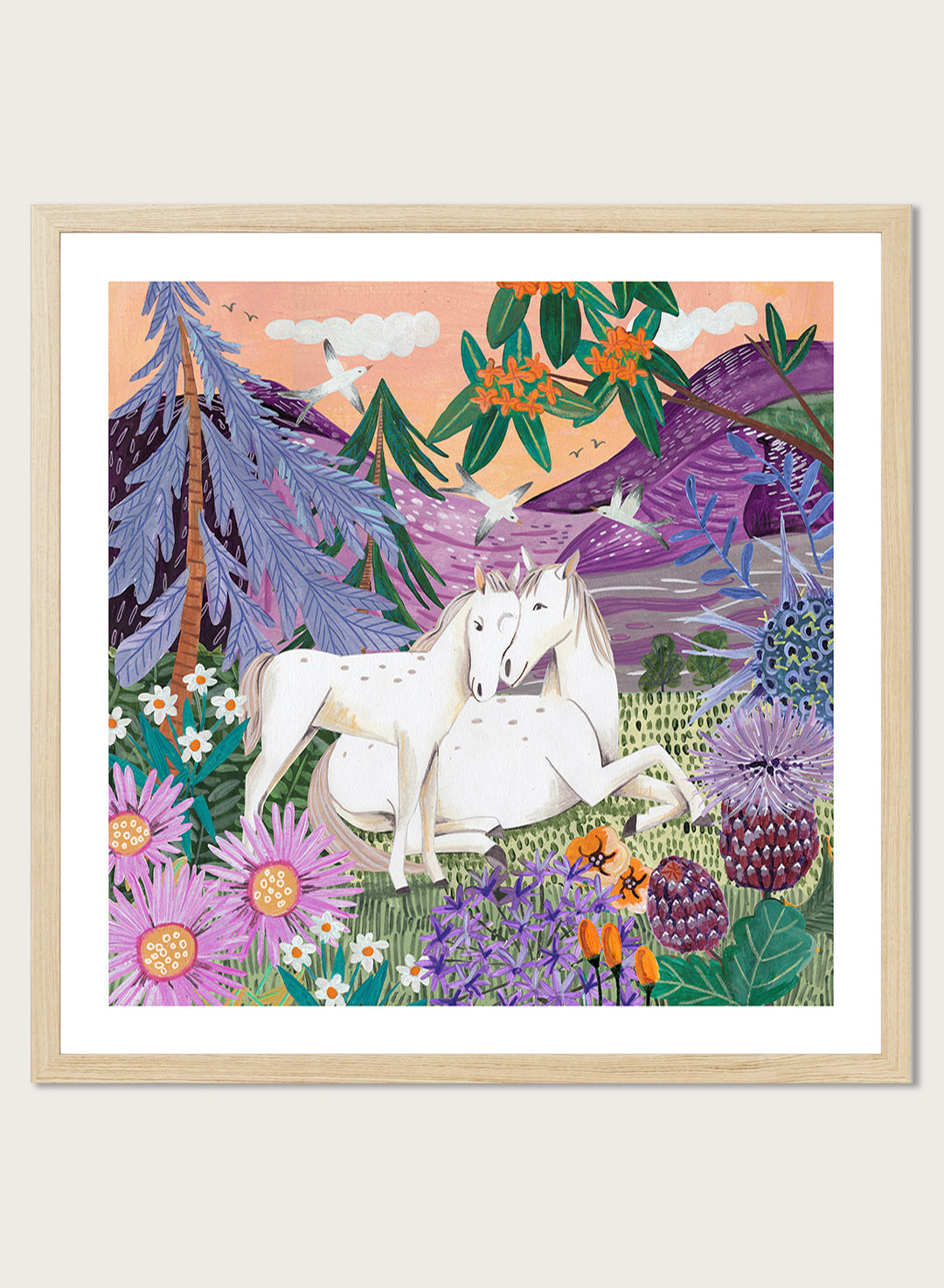 Framed artwork of two horses in a colorful forest scene with flowers and mountains. Horses in the Mountains by Caroline Bonne Müller is a fine art print and wall poster featuring two white horses surrounded by colorful flowers in a mountain landscape.