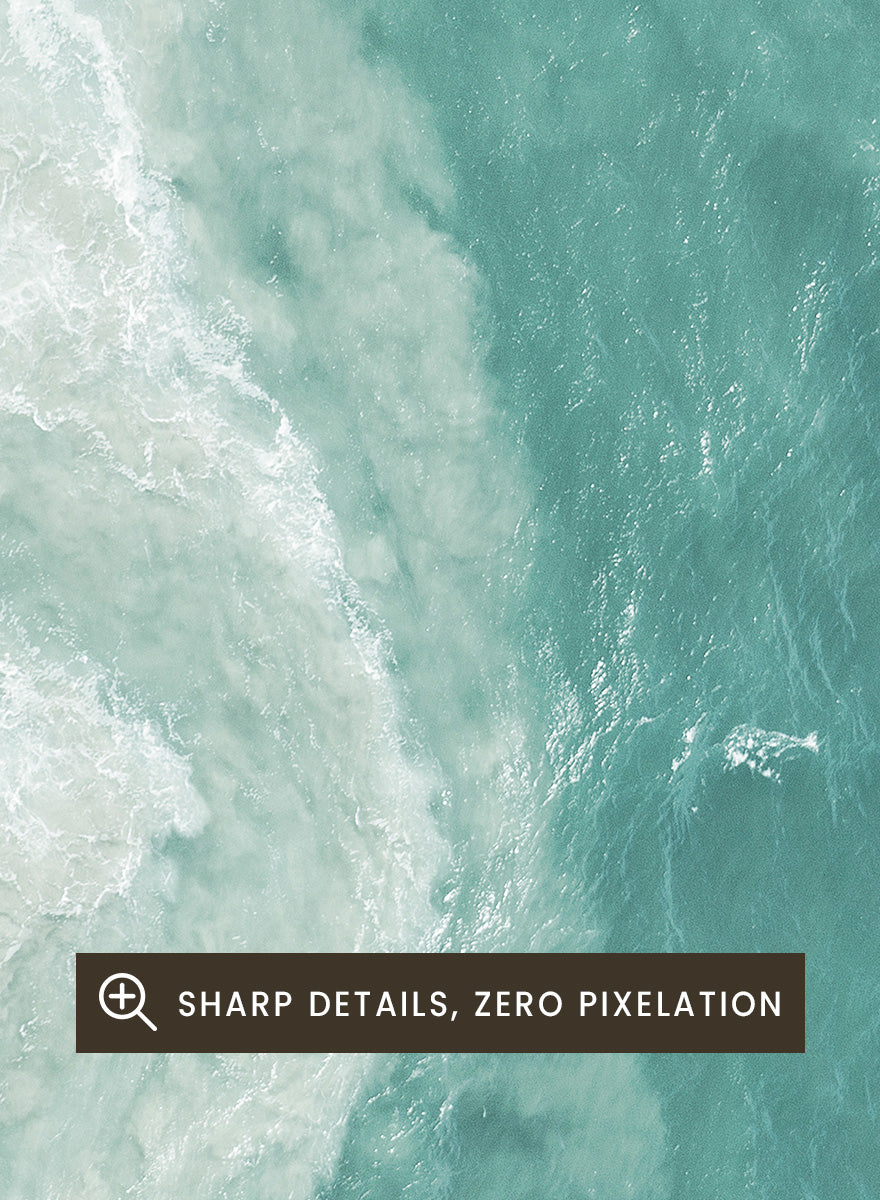 A framed aerial photograph of ocean waves, showing white foam breaking into turquoise and teal water. Ocean’s Edge by Shot by Clint aerial ocean photography print featuring turquoise water, white surf, and layered coastal movement.
