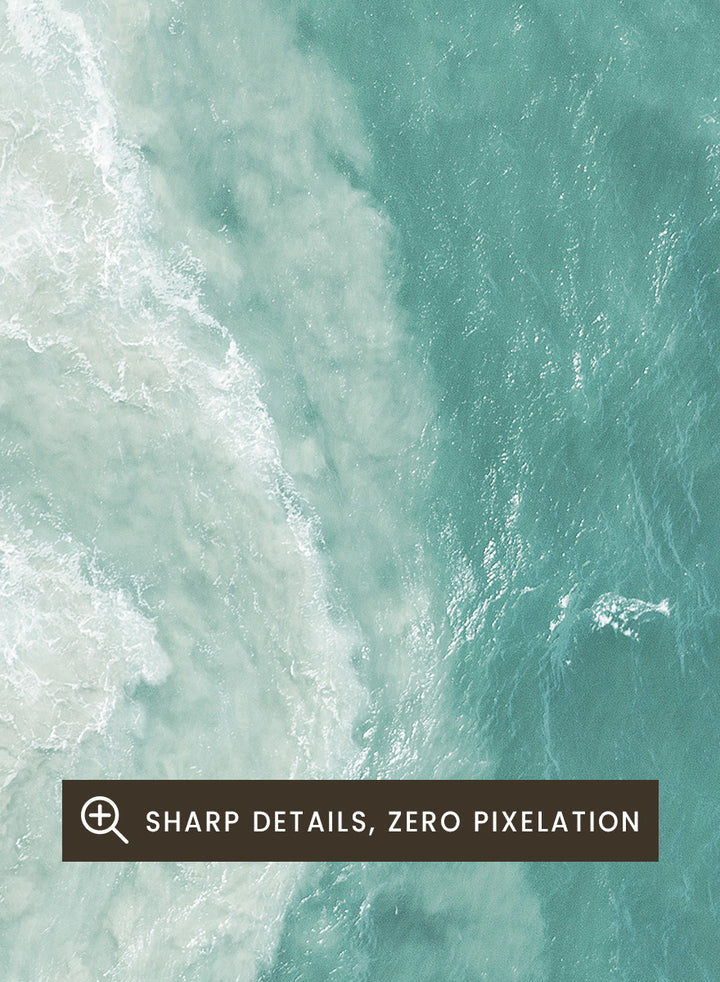 A framed aerial photograph of ocean waves, showing white foam breaking into turquoise and teal water. Ocean’s Edge by Shot by Clint aerial ocean photography print featuring turquoise water, white surf, and layered coastal movement.