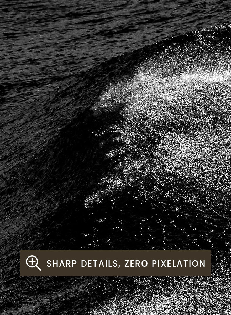 Black and white fine art photographic print of ocean waves, featuring a dramatic wave crest with white foam against dark textured water. Night Wave Cascade by Shot by Clint black-and-white ocean photography print featuring dark rolling waves, sea spray, and dramatic natural movement.
