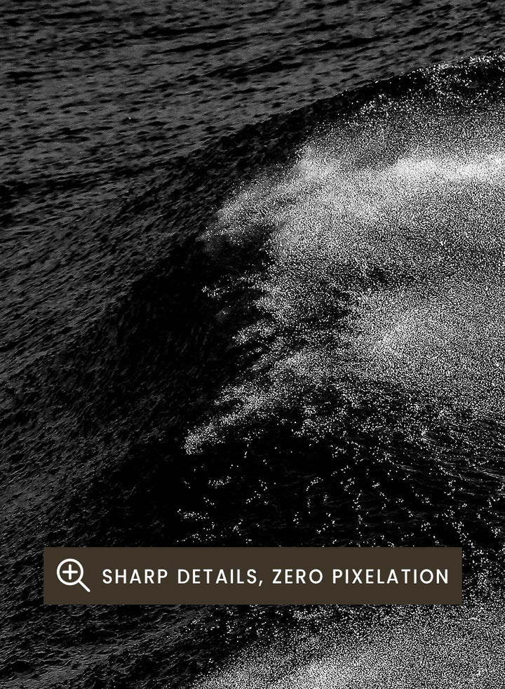 Black and white fine art photographic print of ocean waves, featuring a dramatic wave crest with white foam against dark textured water. Night Wave Cascade by Shot by Clint black-and-white ocean photography print featuring dark rolling waves, sea spray, and dramatic natural movement.