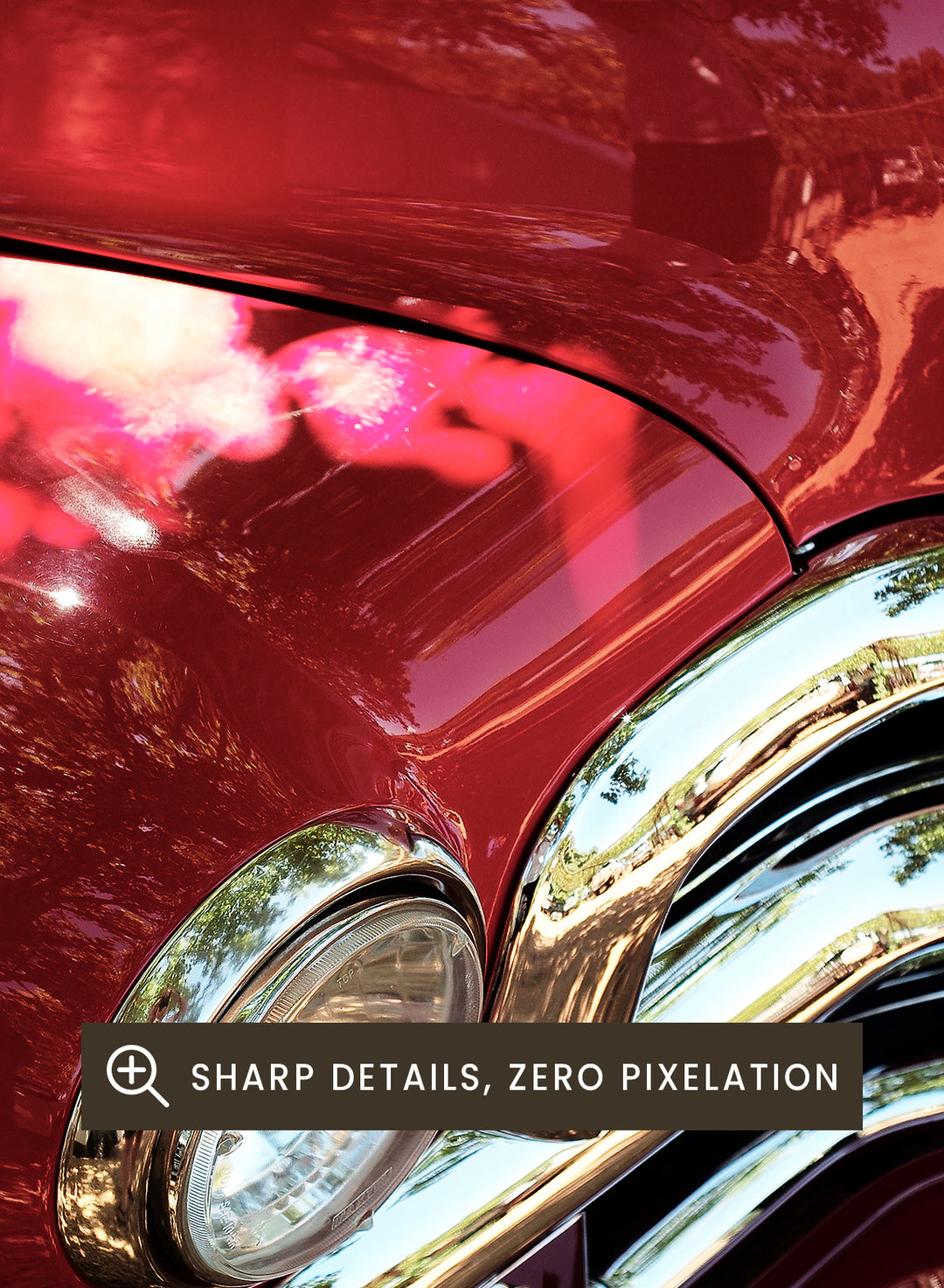 Close-up of a vintage red Chevrolet car body with chrome grille and reflections of trees on the glossy paint, photographed outdoors on mulch. Vintage Red Car by Shot by Clint automotive photography print featuring a classic Chevrolet, deep red paint, polished chrome, and sculptural vintage details.